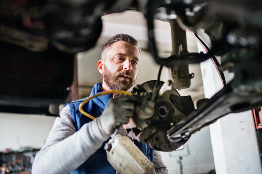 man-mechanic-repairing-a-car-in-a-garage-.jpg